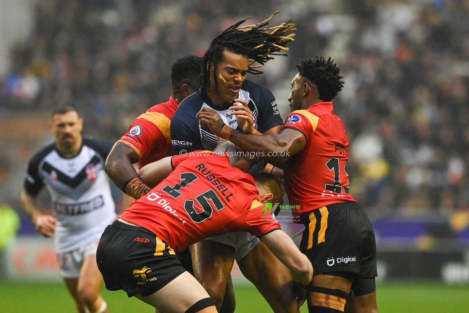 Dom Young of England is tackled by Nixon Putt and Daniel Russell of Papua New Guinea during the Rugby League World Cup 2021 Quarter Final match England vs Papua New Guinea at DW Stadium, Wigan, United Kingdom, 5th November 2022

(Photo by Craig Thomas/News Images)