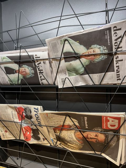 Newspapers in Amsterdam Airport Schipho show images of Her Majesty The Queen