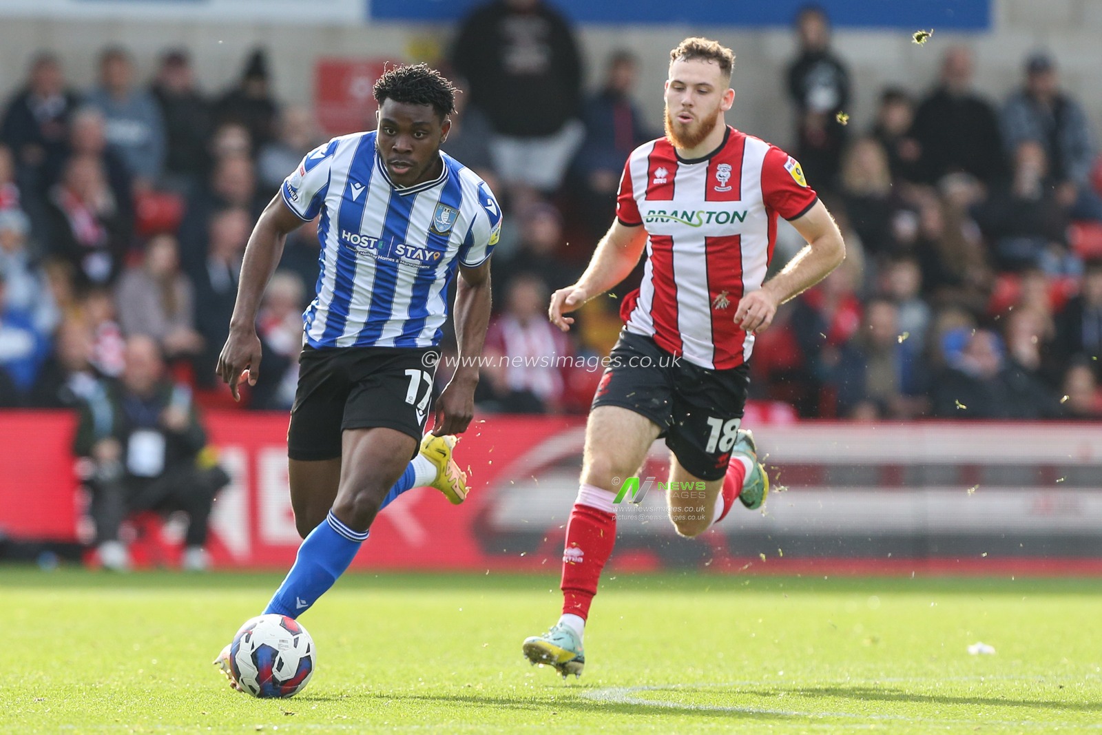 Fisayo Dele Bashiru #17 of Sheffield Wednesday runs with the ball during the Sky Bet League 1 match Lincoln City vs Sheffield Wednesday at Gelder Group Sincil Bank Stadium, Lincoln, United Kingdom, 22nd October 2022

(Photo by Arron Gent/News Images)