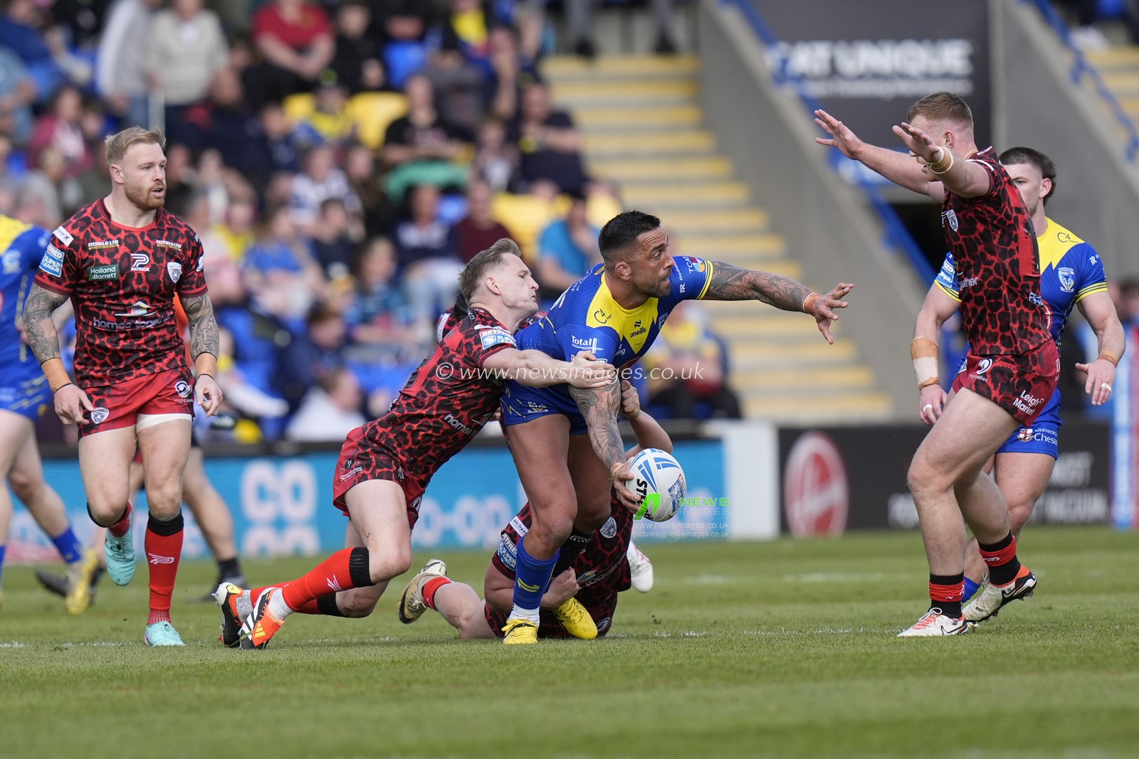 Paul Vaughan of Warrington Wolves looks to offload the ball  during the Betfred Super League Round 8 match Warrington Wolves vs Leigh Leopards at Halliwell Jones Stadium, Warrington, United Kingdom, 20th April 2024

(Photo by Steve Flynn/News Images)