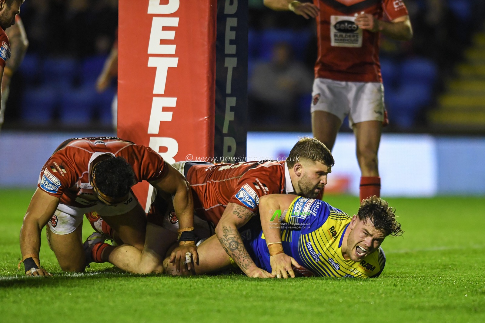 Joe Philbin #8 of Warrington Wolves goes over for a try to make it 20-6