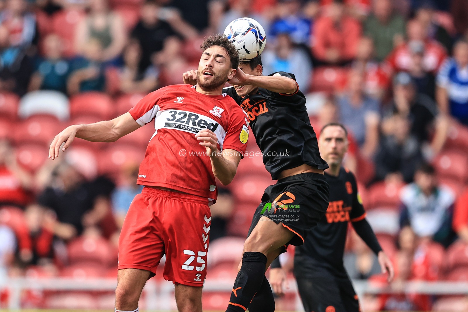 Kenny Dougall #12 of Blackpool and Matt Crooks #25 of Middlesbrough battle for the ball