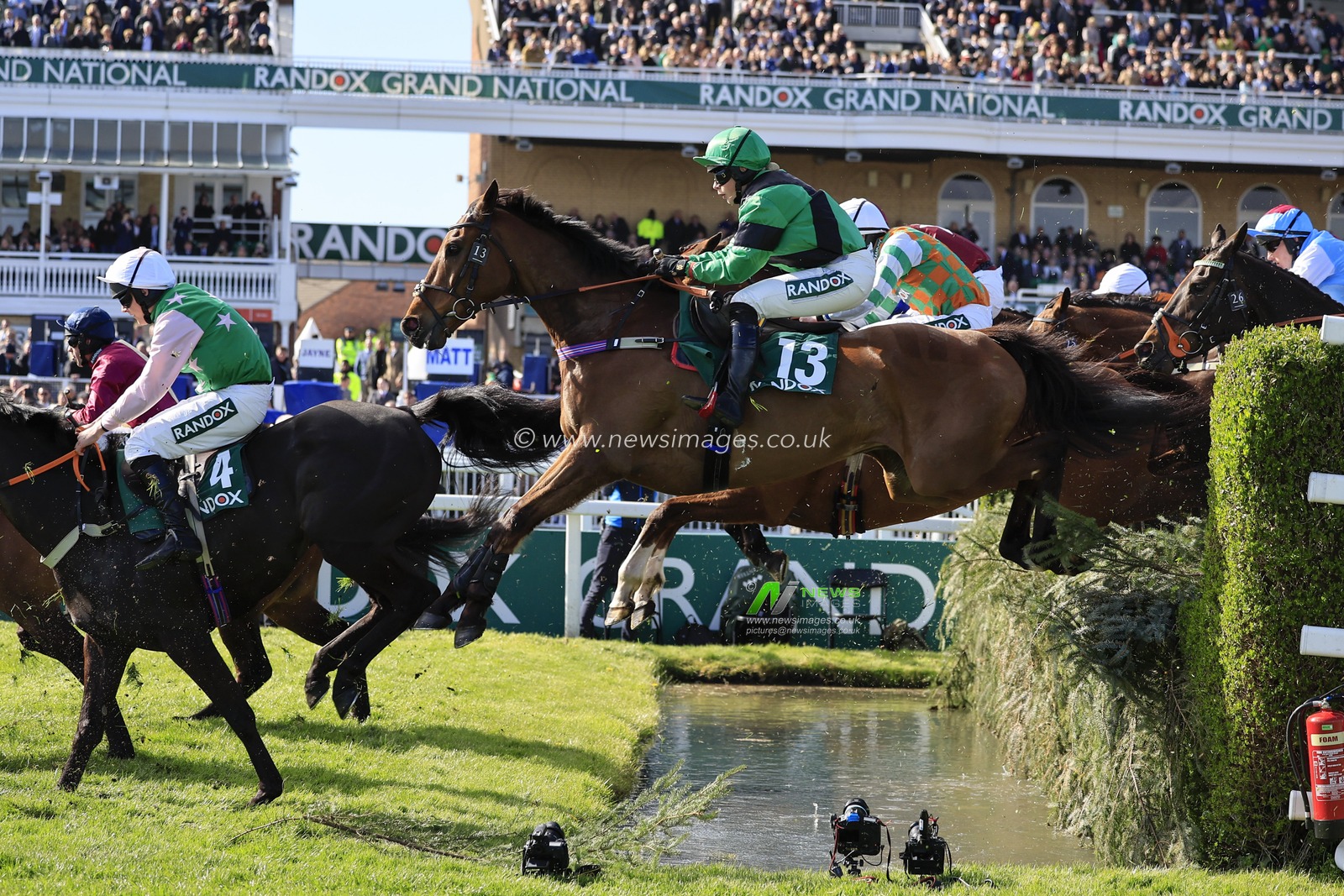 IK  Brunel ridden by Izzie Marshall goes over the water jump during The Randox Foxhunters Open Hunters Chase on Famous Clermont at the Randox Grand National festival 2023 Opening Day at Aintree Racecourse, Liverpool, United Kingdom, 13th April 2023

(Photo by Conor Molloy/News Images)