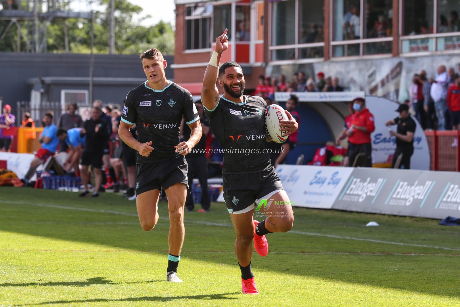 Ricky Leutele #4 of Huddersfield Giants starts to celebrate has he runs for the try line to score his try