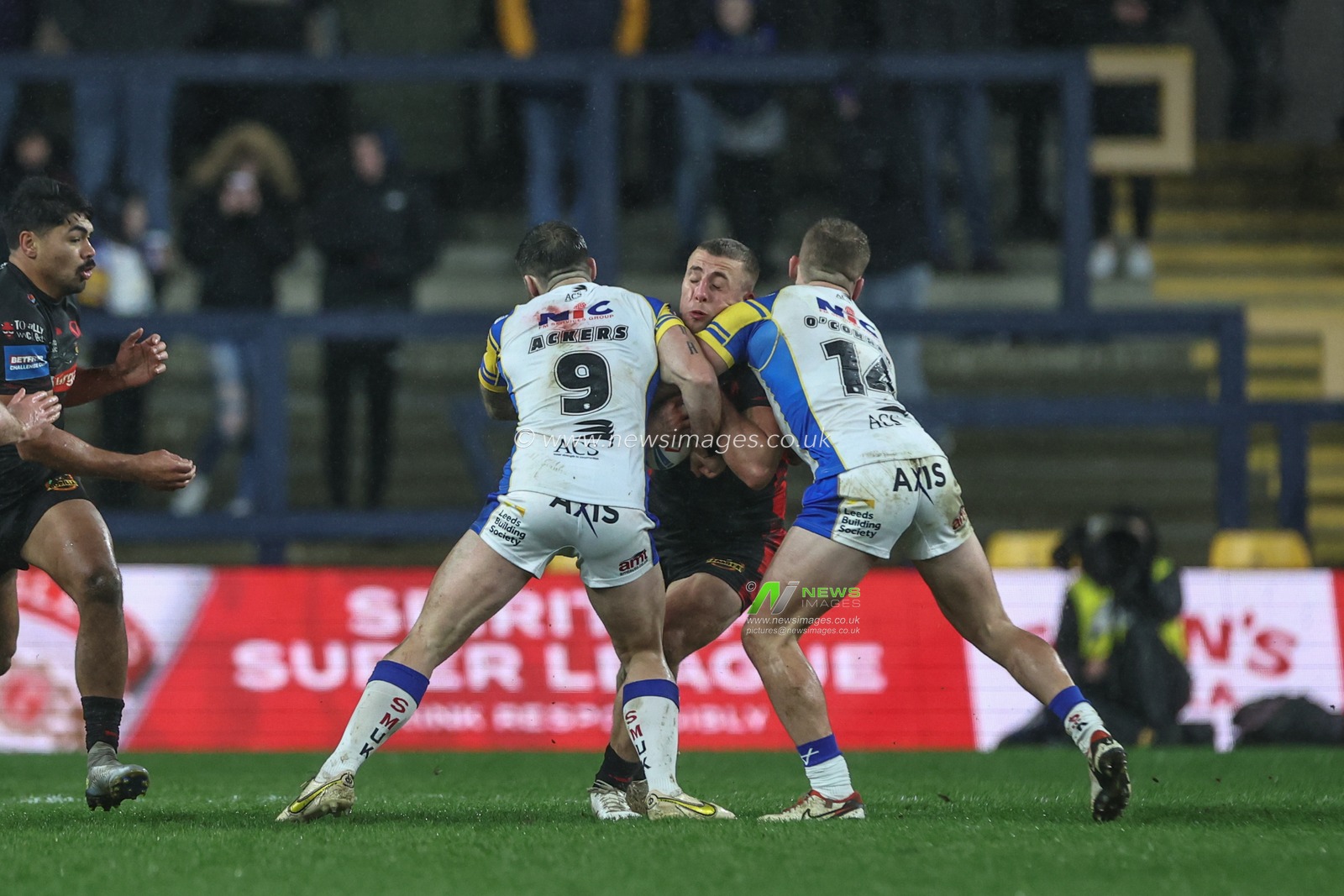 Jake Wingfield of St. Helens is tackled by Andy Ackers of Leeds Rhinos and Jarrod Oâ€™Connor of Leeds Rhinos during the Betfred Challenge Cup Sixth Round match Leeds Rhinos vs St Helens at Headingley Stadium, Leeds, United Kingdom, 22nd March 2024

(Photo by Mark Cosgrove/News Images)