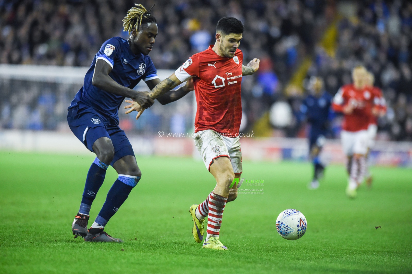 11th January 2020, Oakwell, Barnsley, England; Sky Bet Championship, Barnsley v Huddersfield Town : Alex Mowatt (27) of Barnsley FC holds off Trevor Chalabah (8) of Huddersfield Town

Credit: Dean Williams/News Images