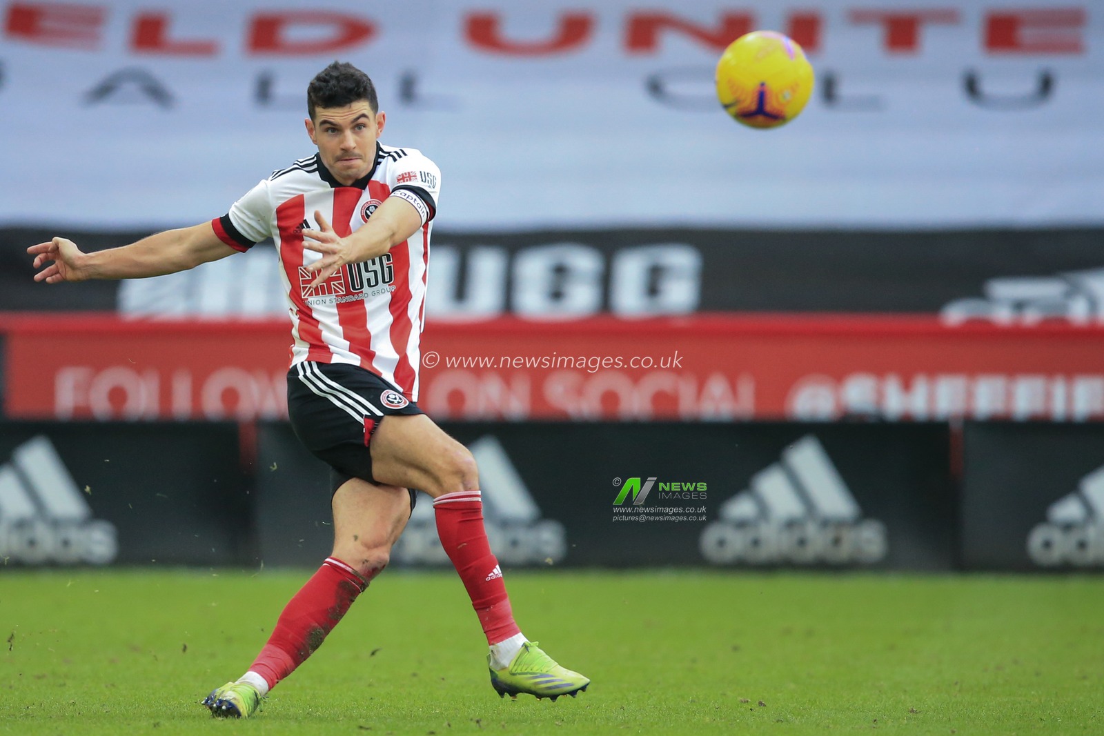 John Egan #12 of Sheffield United passes the ball down field