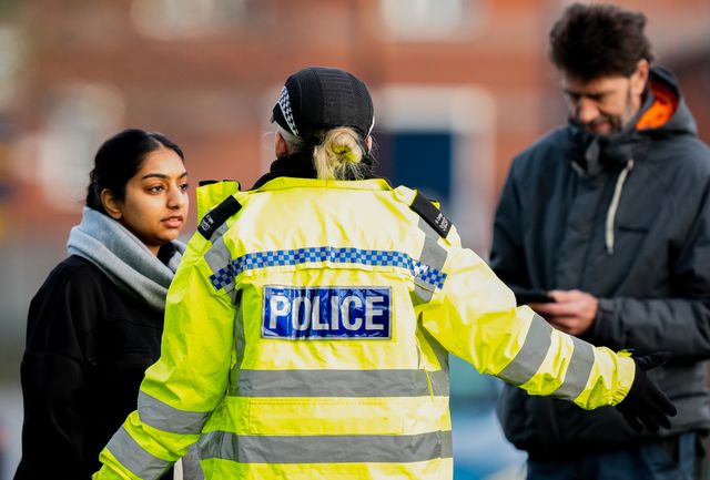 A police officer speaks to members of the public outside an address on Cambridge Street, Derby, during a Major Explosives Incident in Derby that began on Thursday December 4 when police executed a warrant at an address on Vulcan Street, Derby, that saw two men arrested on suspicion of explosives offences and 200 homes evacuated (Maynard Manyowa / News Images)