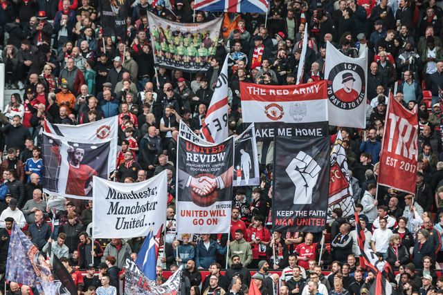 Manchester United fans hold up flags before the game during the Premier League match Manchester United vs Brentford at Old Trafford, Manchester, United Kingdom on 27 April 2026

(Photo by Mark Cosgrove/News Images)