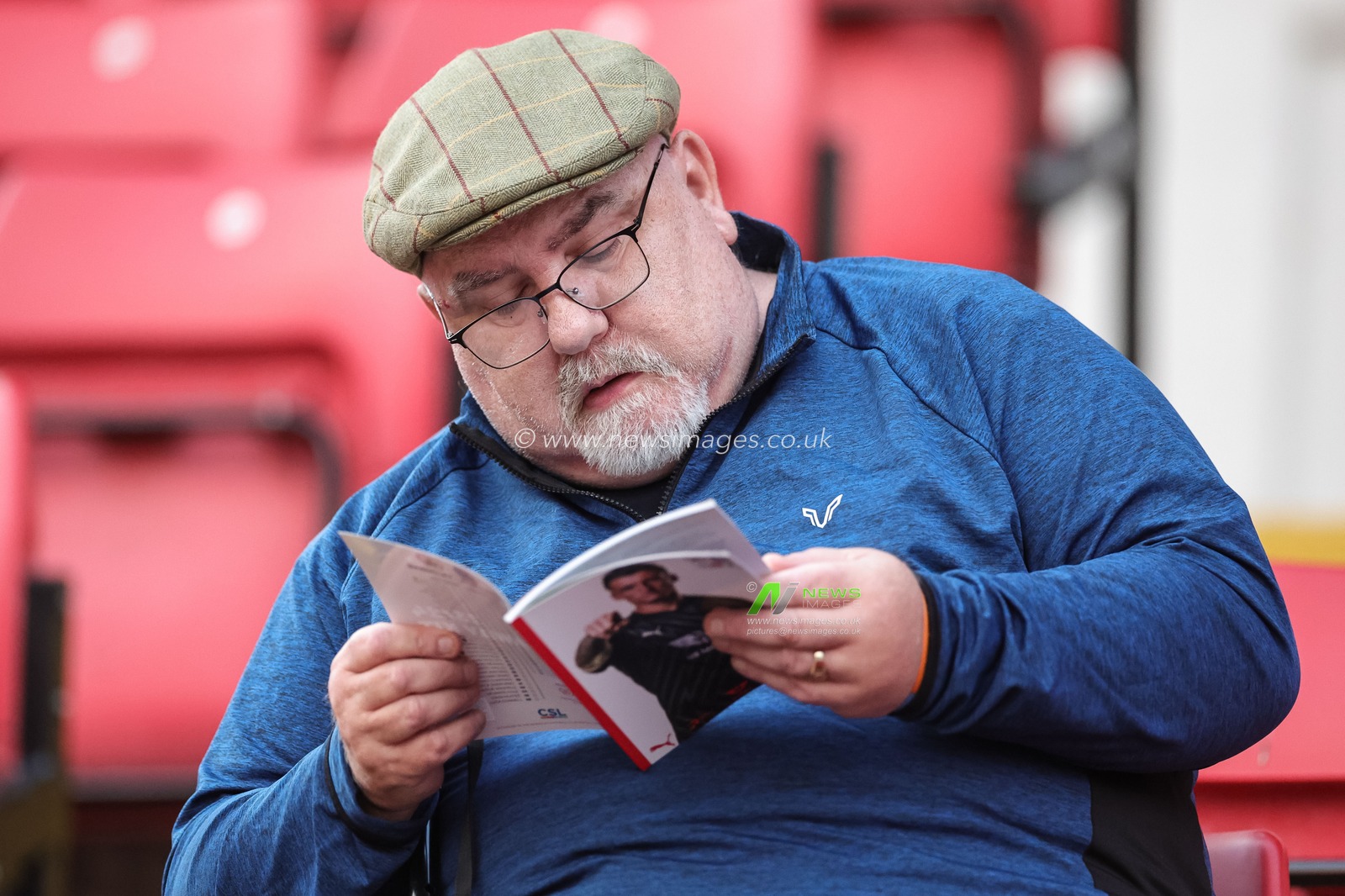 A Barnsley fan reading todays match day program with Liam Roberts #1 of Barnsley on the front cover during the Sky Bet League 1 match Barnsley vs Portsmouth at Oakwell, Barnsley, United Kingdom, 19th September 2023

(Photo by Mark Cosgrove/News Images)