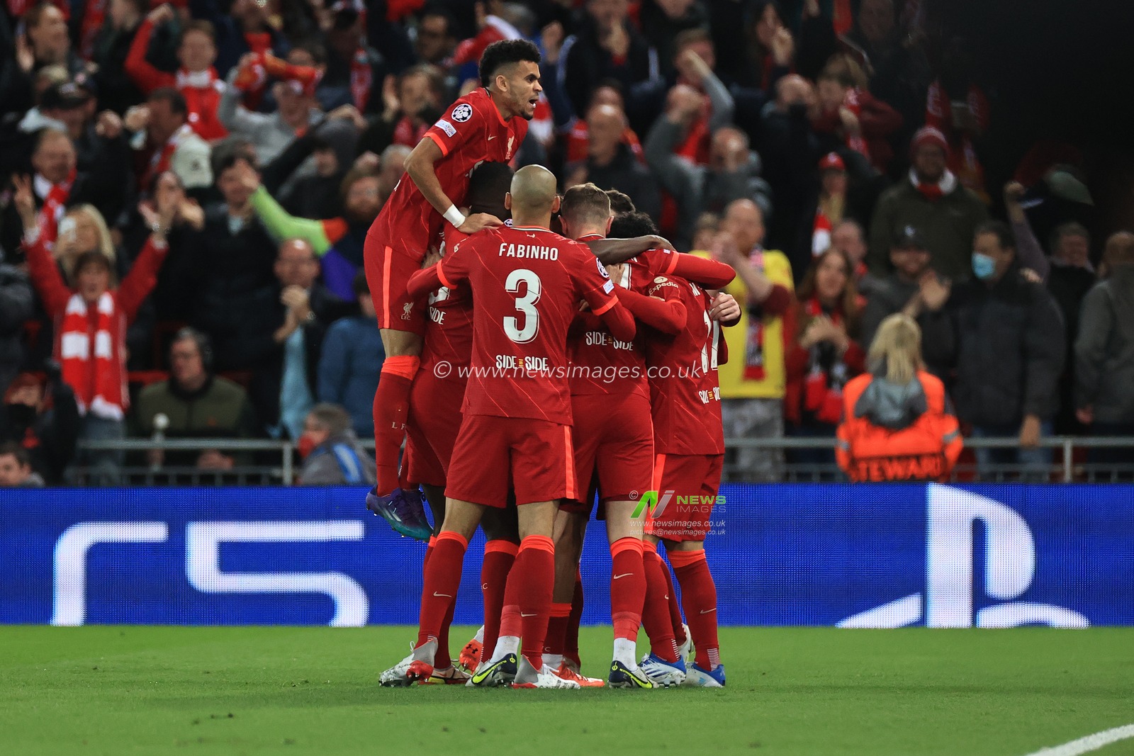 Jordan Henderson #14 of Liverpool celebrates scoring the opening goal with team mates