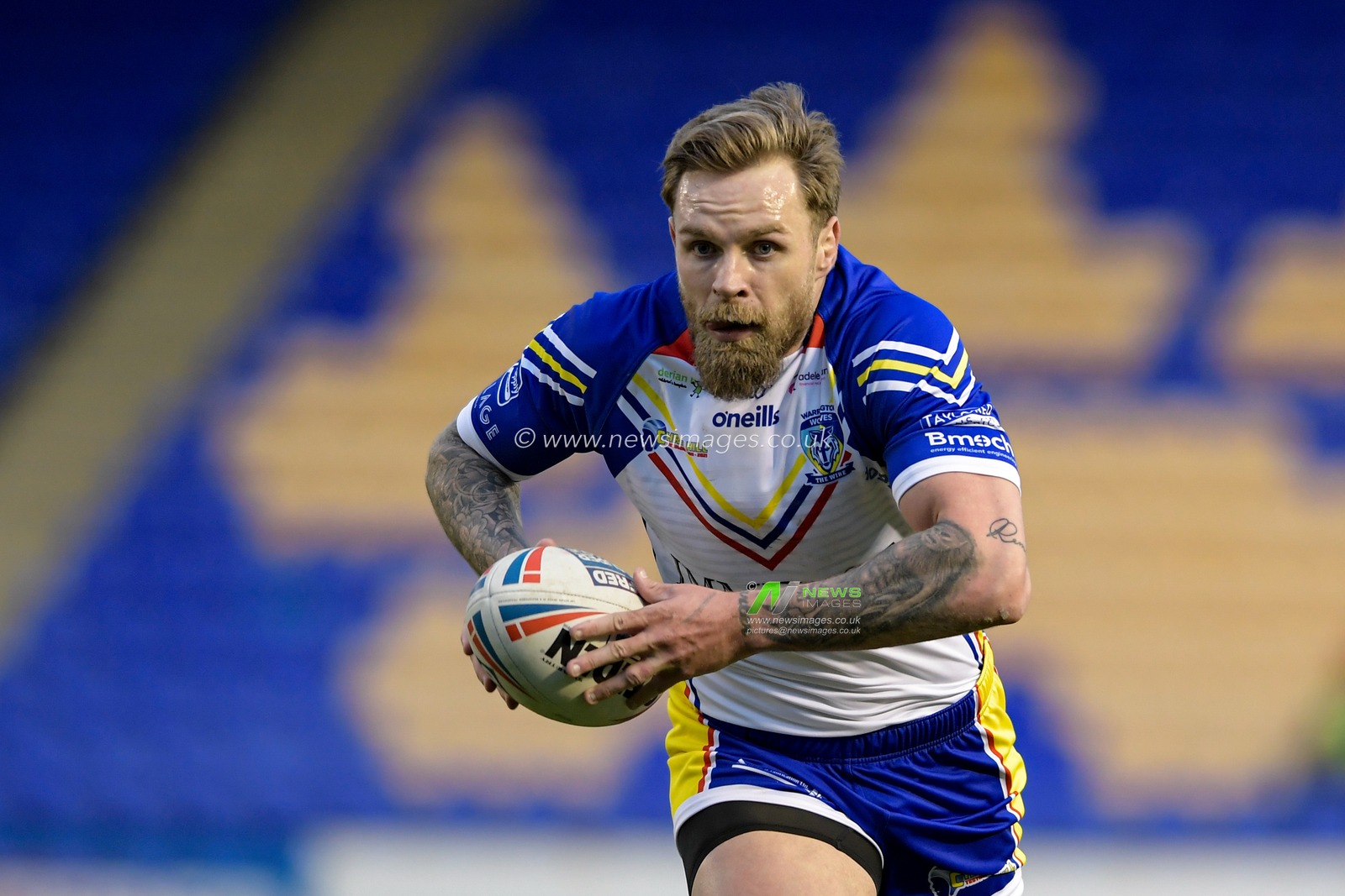 Blake Austin (6) of Warrington Wolves runs forward with the ball