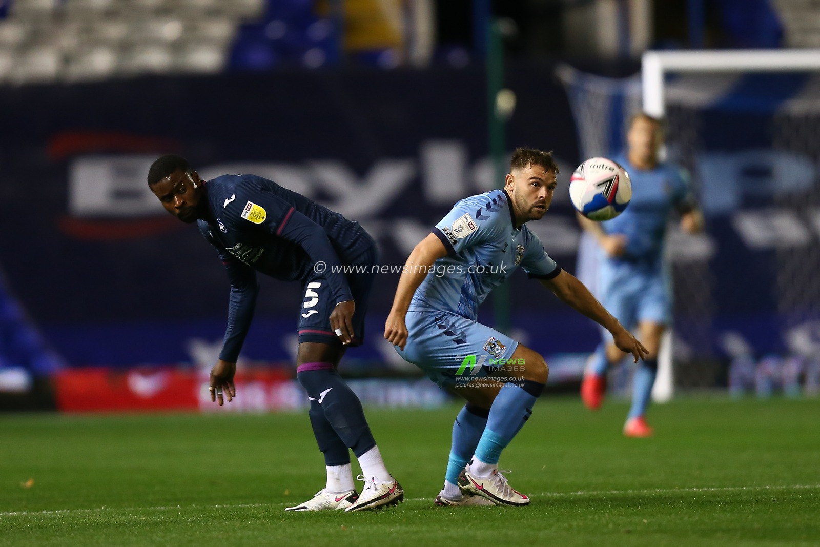 Marc Guehi (5) of Swansea City and Matt Godden (24) of Coventry City compete for the ball