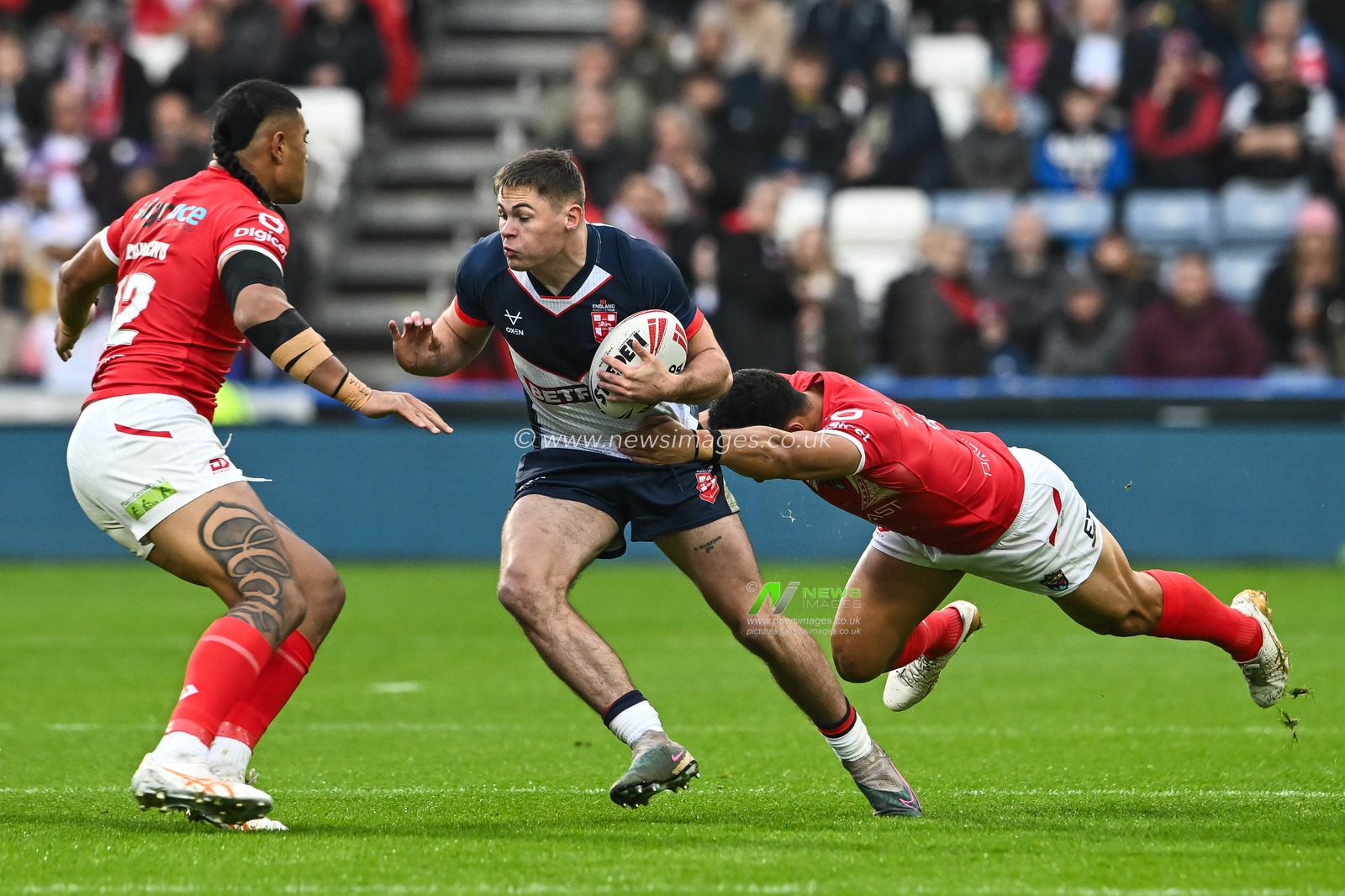 Jack Welsby of England breaks the tackle of Will Penisini of Tonga during the Rugby League International match England vs Tonga at John Smith's Stadium, Huddersfield, United Kingdom, 28th October 2023

(Photo by Craig Thomas/News Images)