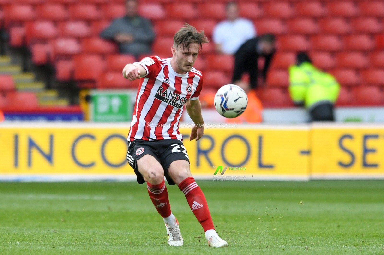 Ben Davies #22 of Sheffield United clears the ball