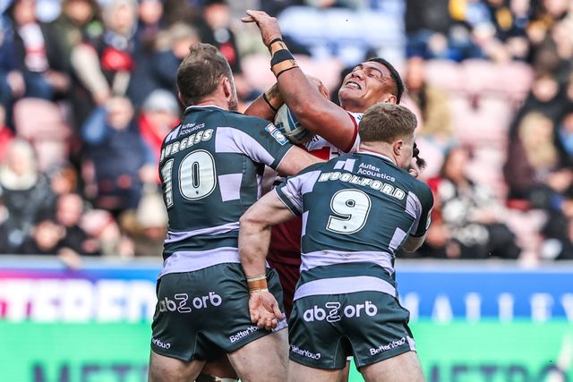 Patrick Mago of Wigan Warriors is tackled by Tom Burgess of Huddersfield Giants and Zac Woolford of Huddersfield Giants during the Betfred Super League round 6 match Wigan Warriors vs Huddersfield Giants at The Brick Community Stadium, Wigan, United Kingdom on 28 March 2026

(Photo by Alfie Cosgrove/News Images)