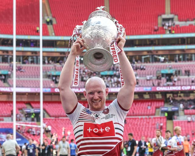 Liam Farrell of Wigan Warriors lifts the Betfred Challenge Cup Trophy in front of the Wigan fans during the Betfred Challenge Cup Final match Wigan Warriors vs Hull KR at Wembley Stadium, London, United Kingdom on 30 May 2026

(Photo by Mark Cosgrove/News Images)