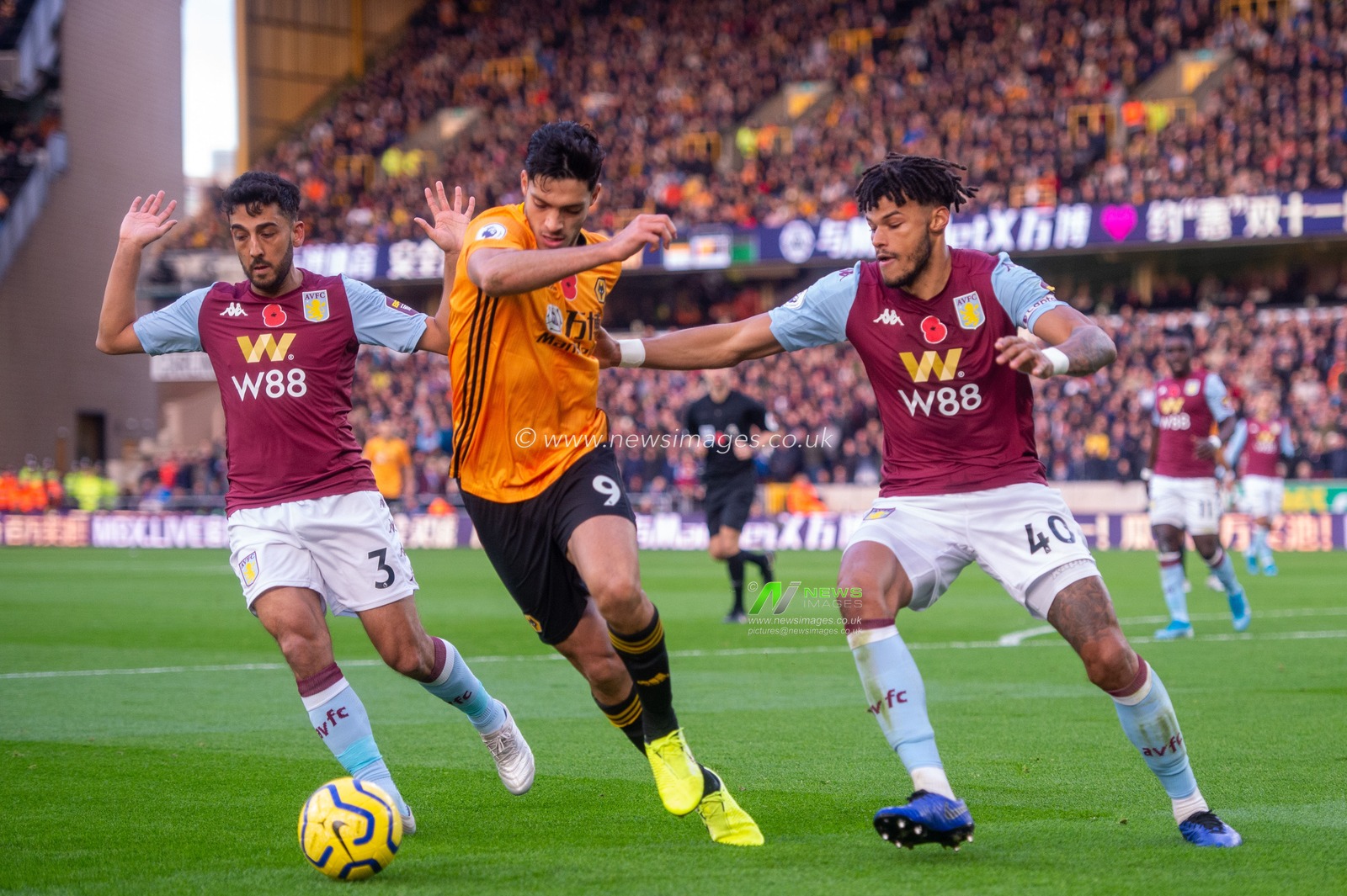 10th November 2019, Molineux, Wolverhampton, England; Premier League, Wolverhampton Wanderers v Aston Villa : Raul Jimenez (09) of Wolverhampton Wanderers under pressure from Tyrone Mings (40) of Aston Villa

Credit: Gareth Dalley/News Images