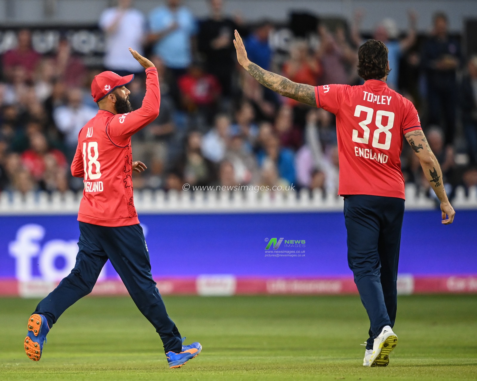 Reece Topley of England celebrates the wicket of Rilee Rossouw of South Africa with Moeen Ali of England