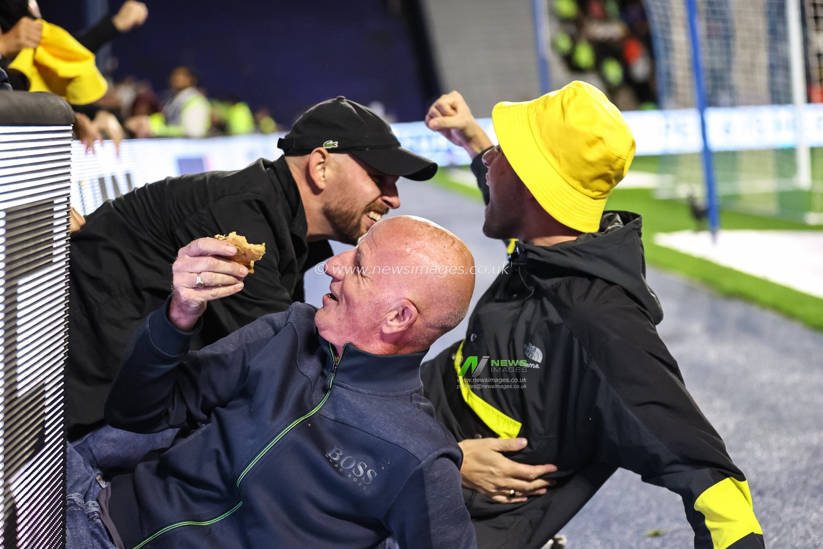 A Leeds United fan manages to hold onto his pie as they fall through the LED advertising boards after celebrating the goal of Dan James of Leeds United during the Sky Bet Championship match Sheffield Wednesday vs Leeds United at Hillsborough, Sheffield, United Kingdom, 23rd August 2024

(Photo by Mark Cosgrove/News Images)