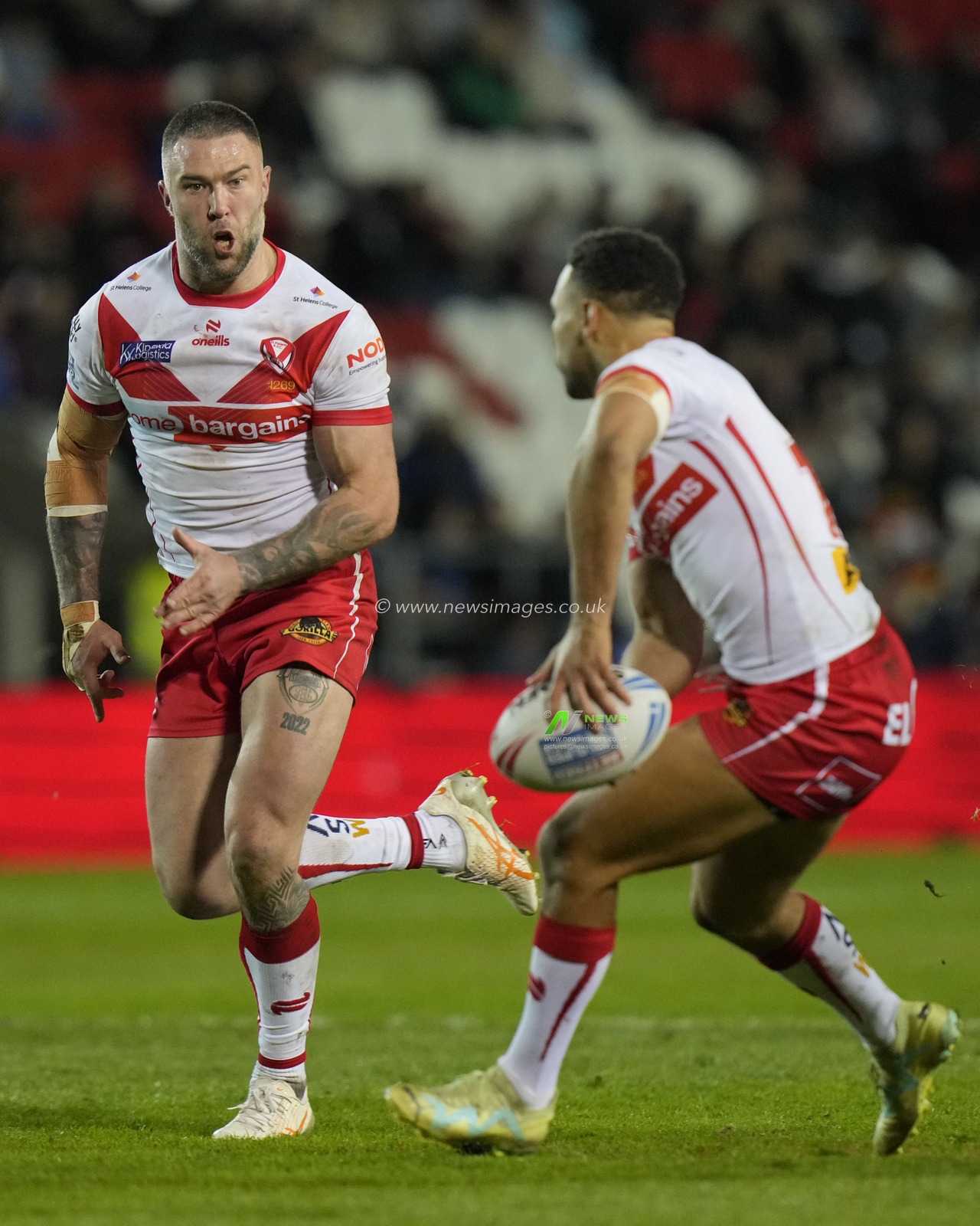 Moses Mbye of St. Helens passes to Curtis Sironen of St. Helens during the Betfred Super League  Round 8 match St Helens vs Hull FC at Totally Wicked Stadium, St Helens, United Kingdom, 19th April 2024

(Photo by Steve Flynn/News Images)