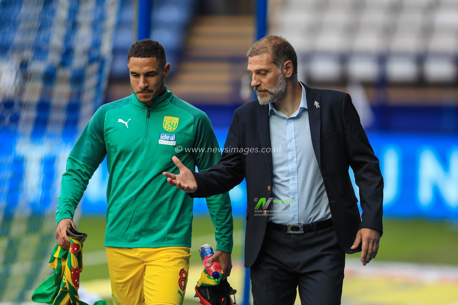 Slaven Bilic manager of West Bromwich Albion talks to Jake Livermore (8) of West Bromwich Albion as the walk out