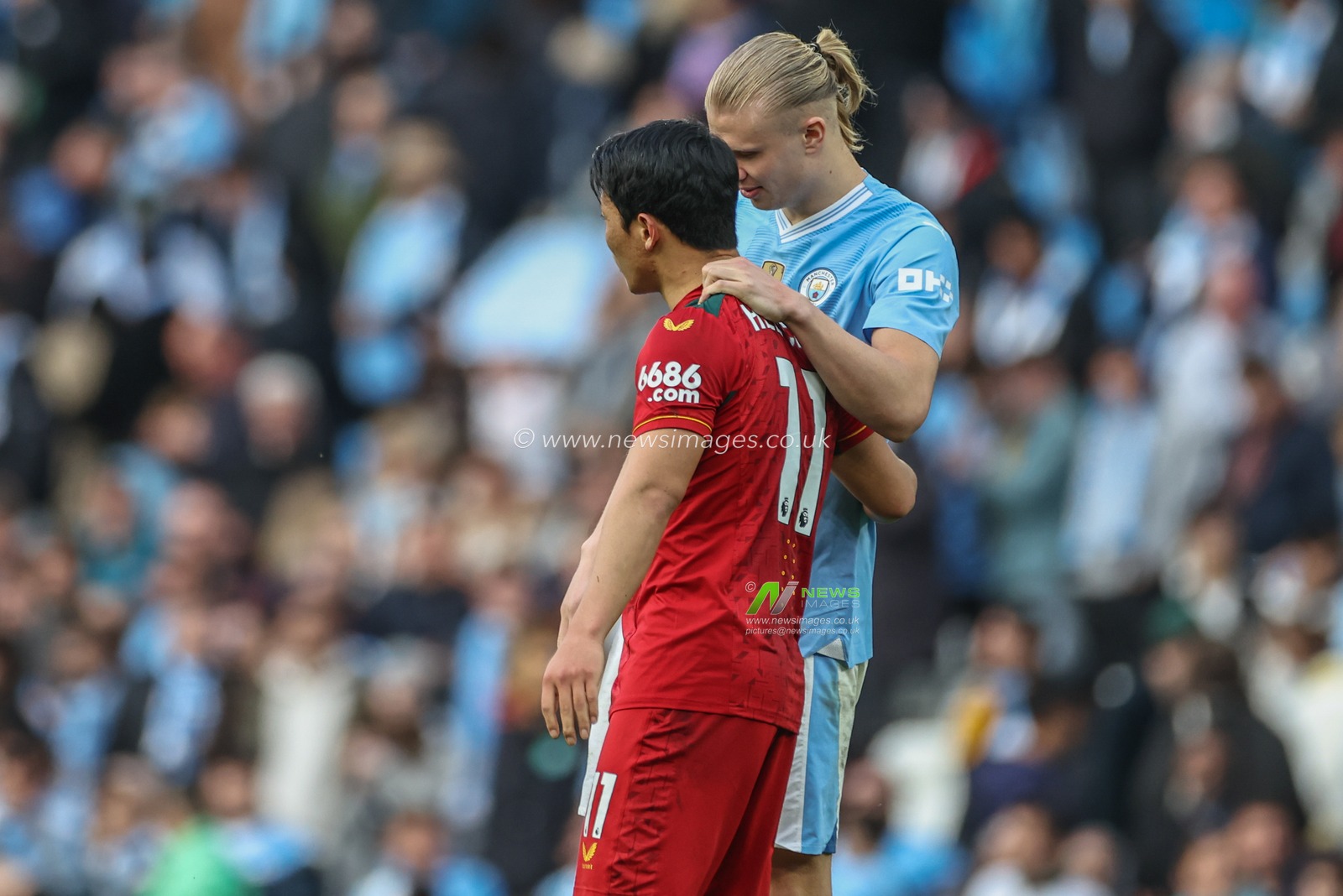 Erling Haaland  of Manchester City embraces Hwang Hee-Chan of Wolverhampton Wanderers after the game during the Premier League match Manchester City vs Wolverhampton Wanderers at Etihad Stadium, Manchester, United Kingdom, 4th May 2024

(Photo by Mark Cosgrove/News Images)