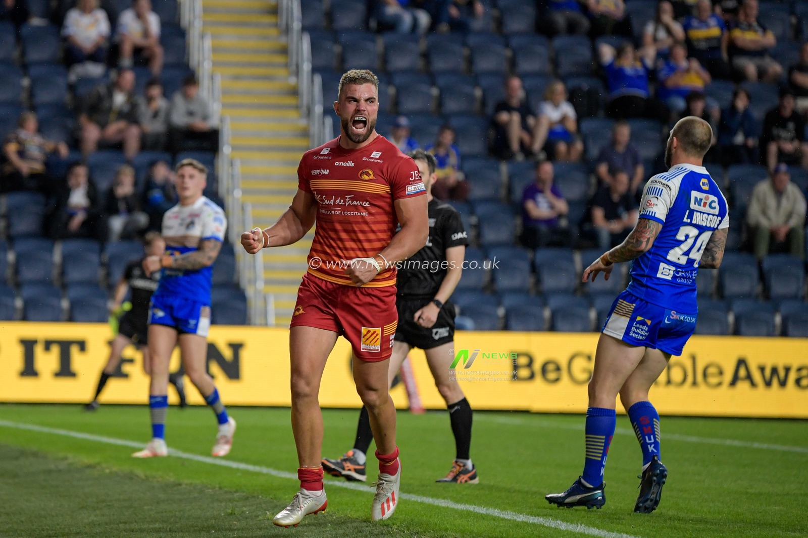 Mike McMeeken (12) of Catalans Dragons celebrates scoring a try to make it 18-18
