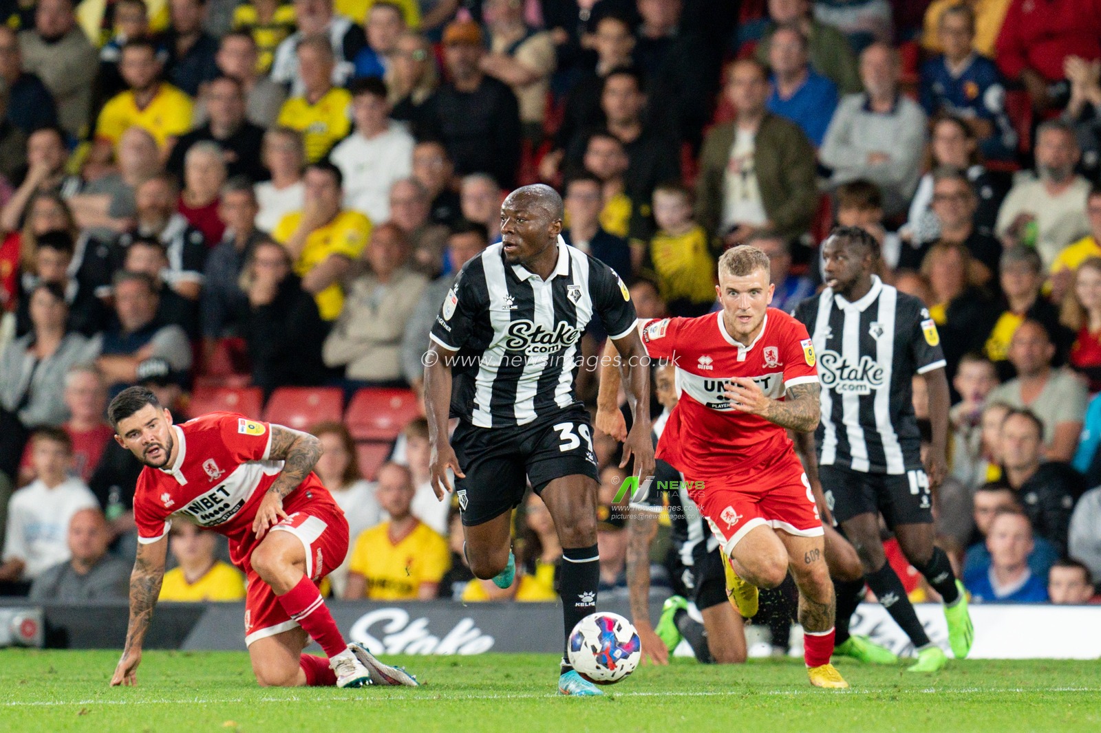 Edo Kayembe #39 of Watford battle for the ball Alex Mowatt #4 of Middlesbrough
