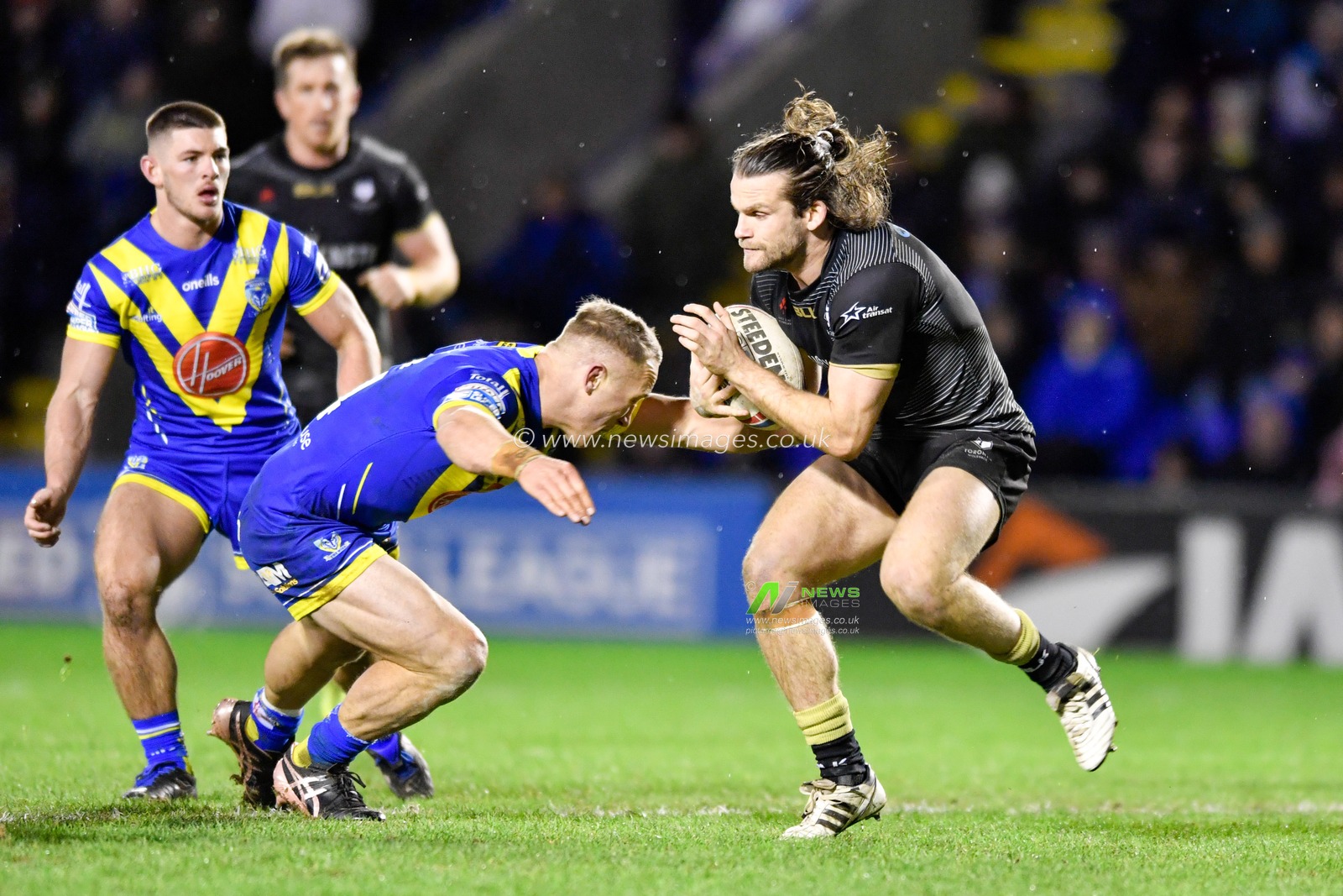 21st February 2020, Halliwell Jones Stadium, Warrington, England; Betfred Super League, Warrington Wolves v Toronto Wolfpack : Jason Clark (14) of Warrington Wolves attempts to tackle Liam Kay (5) of Toronto Wolfpack