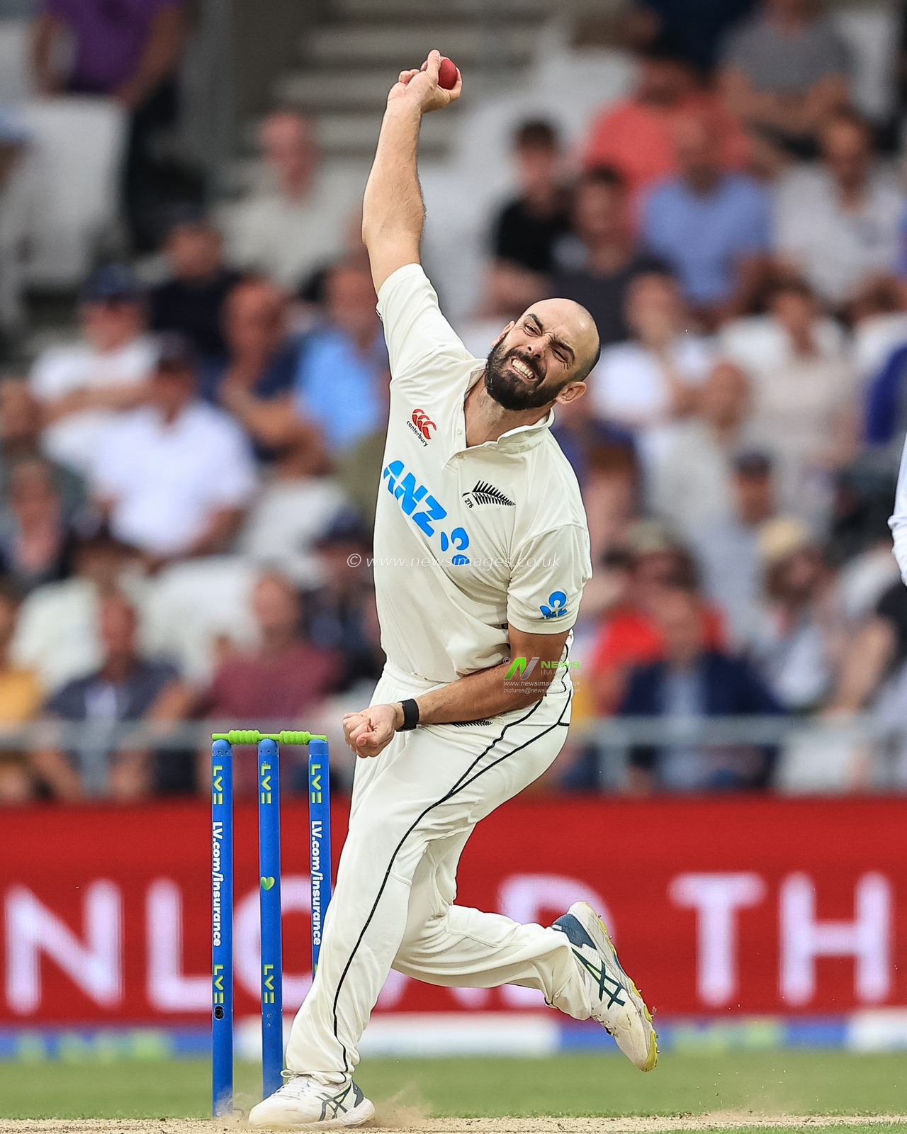 Daryl Mitchell of New Zealand delivers the ball