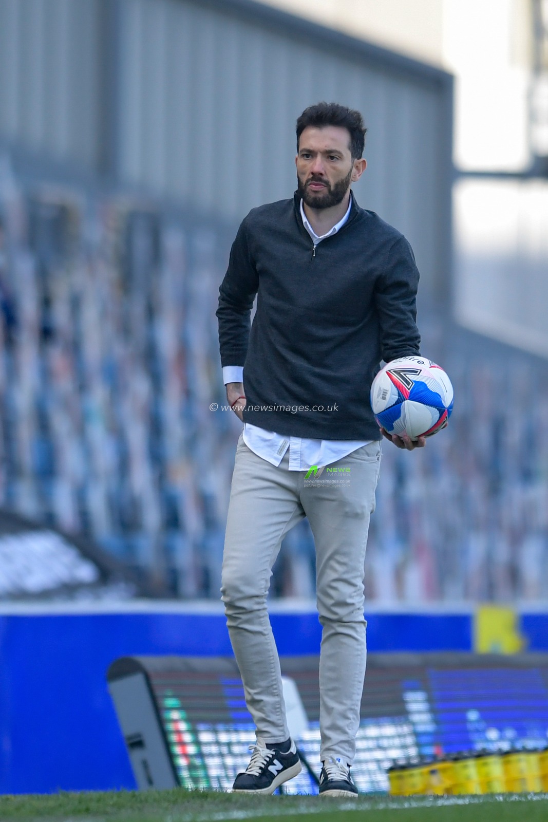 Carlos Corberan manager of Huddersfield Town retrieves the ball