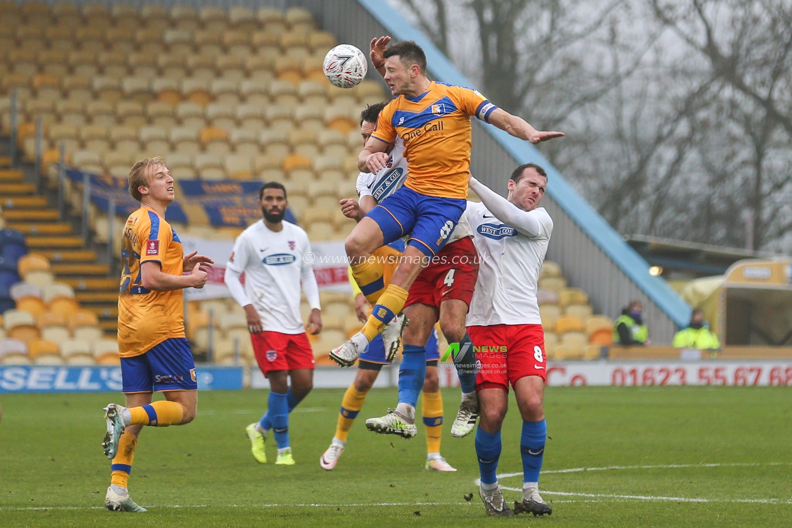 Ollie Clarke #8 of Mansfield Town wins the high ball