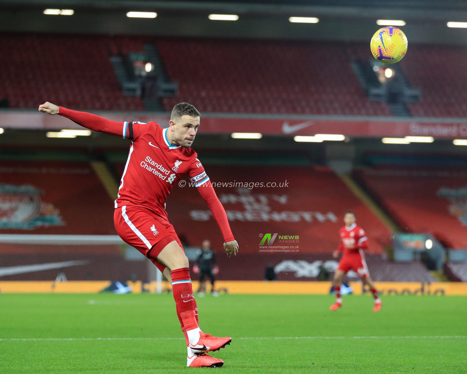 Jordan Henderson #14 of Liverpool crosses the ball into the box