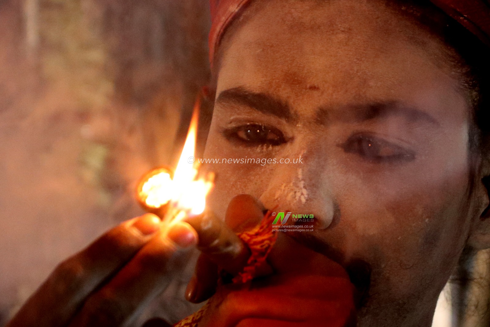 An Indian sadhu (Hindu holy man) is smoking cannabis at a transit camp of the Gangasagar fair in Kolkata, India, on January 7, 2025. The Gangasagar Mela is an annual Hindu festival held at Gangasagar, West Bengal, where the Ganges River meets the Bay of Bengal. The fair takes place at Kapilmuni's ashram on Gangasagar every year on Makar Sankranti.Pictures by Debajyoti Chakraborty.(Photo: Debajyoti Chakraborty/News Images)
