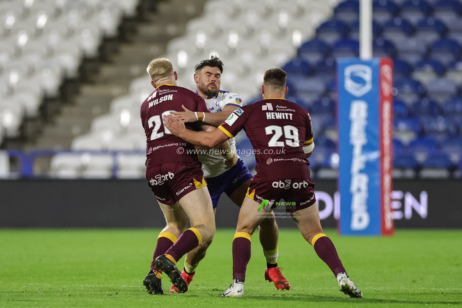 Joe Philbin #15 of Warrington Wolves is tackled by 
Oliver Wilson of Huddersfield Giantsand Sam Hewitt of Huddersfield Giants during the Betfred Super League Round 27 match Huddersfield Giants vs Warrington Wolves at John Smith's Stadium, Huddersfield, United Kingdom, 22nd September 2023

(Photo by Mark Cosgrove/News Images)
