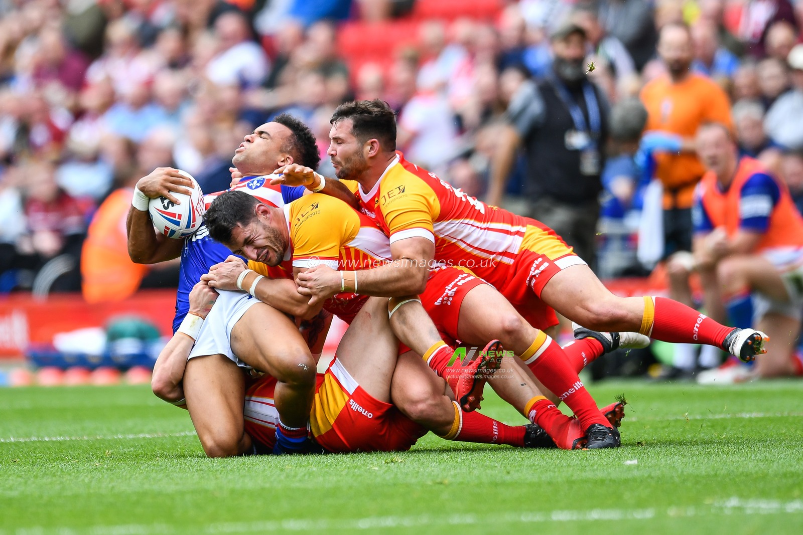 25th May 2019 , Anfield Stadium, Liverpool, England; Dacia Magic Weekend, Betfred Super League Round 16, Wakefield Trinity vs Catalans Dragons ; Mason Caton-Brown (34) of Wakefield Trinity is tackled by 3 Catalans Dragons defenders

Credit: Craig Thomas/News Images