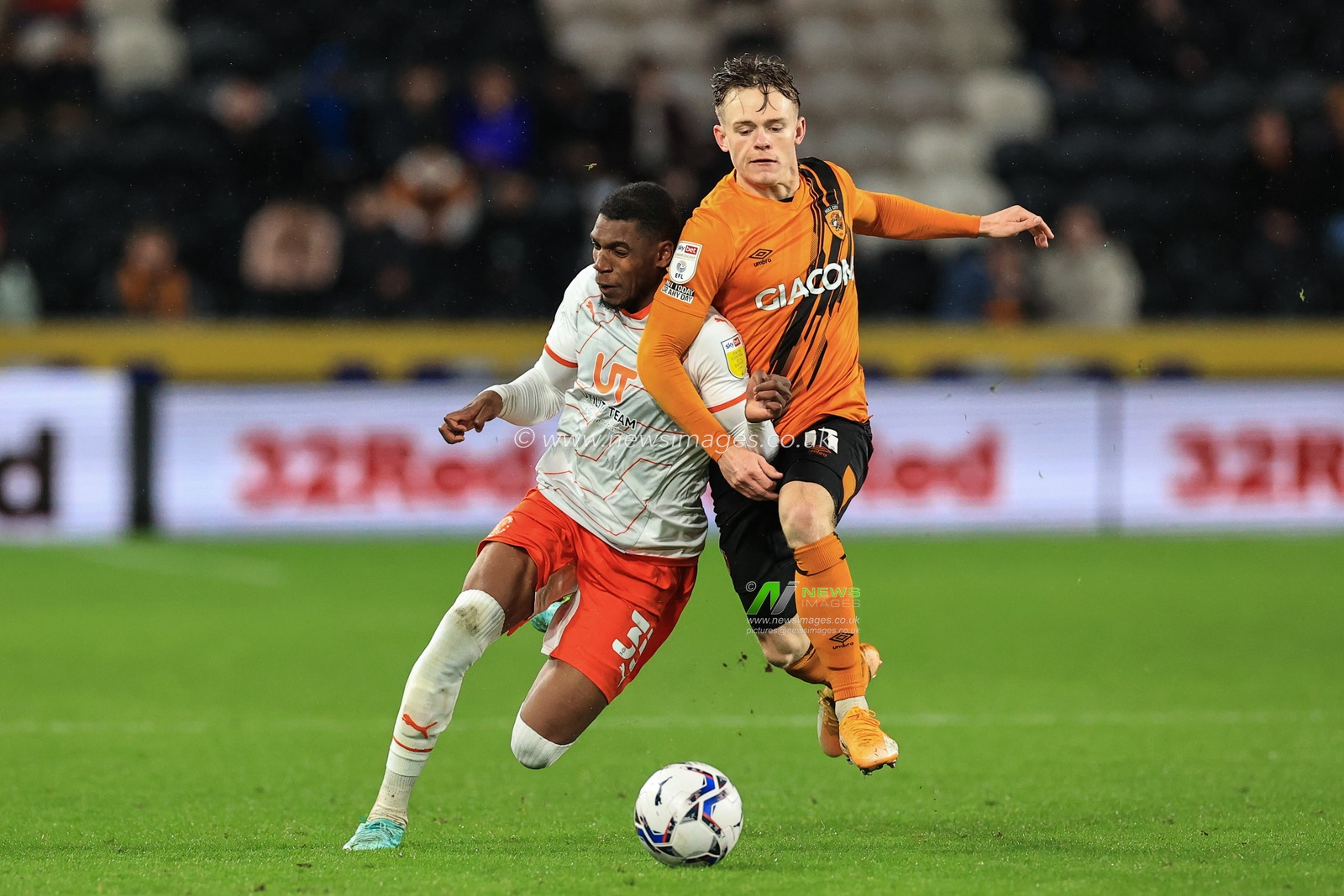 Dujon Sterling #35 of Blackpool and Keane Lewis-Potter #11 of Hull City battle for the ball