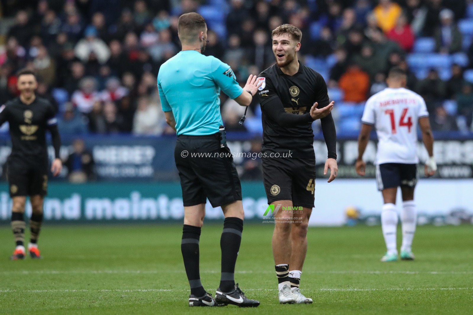 John Mcatee of Barnsley reacts to referee John Busby after he gives a free kick to Bolton during the Sky Bet League 1 match Bolton Wanderers vs Barnsley at Toughsheet Community Stadium, Bolton, United Kingdom, 3rd February 2024

(Photo by Alfie Cosgrove/News Images)