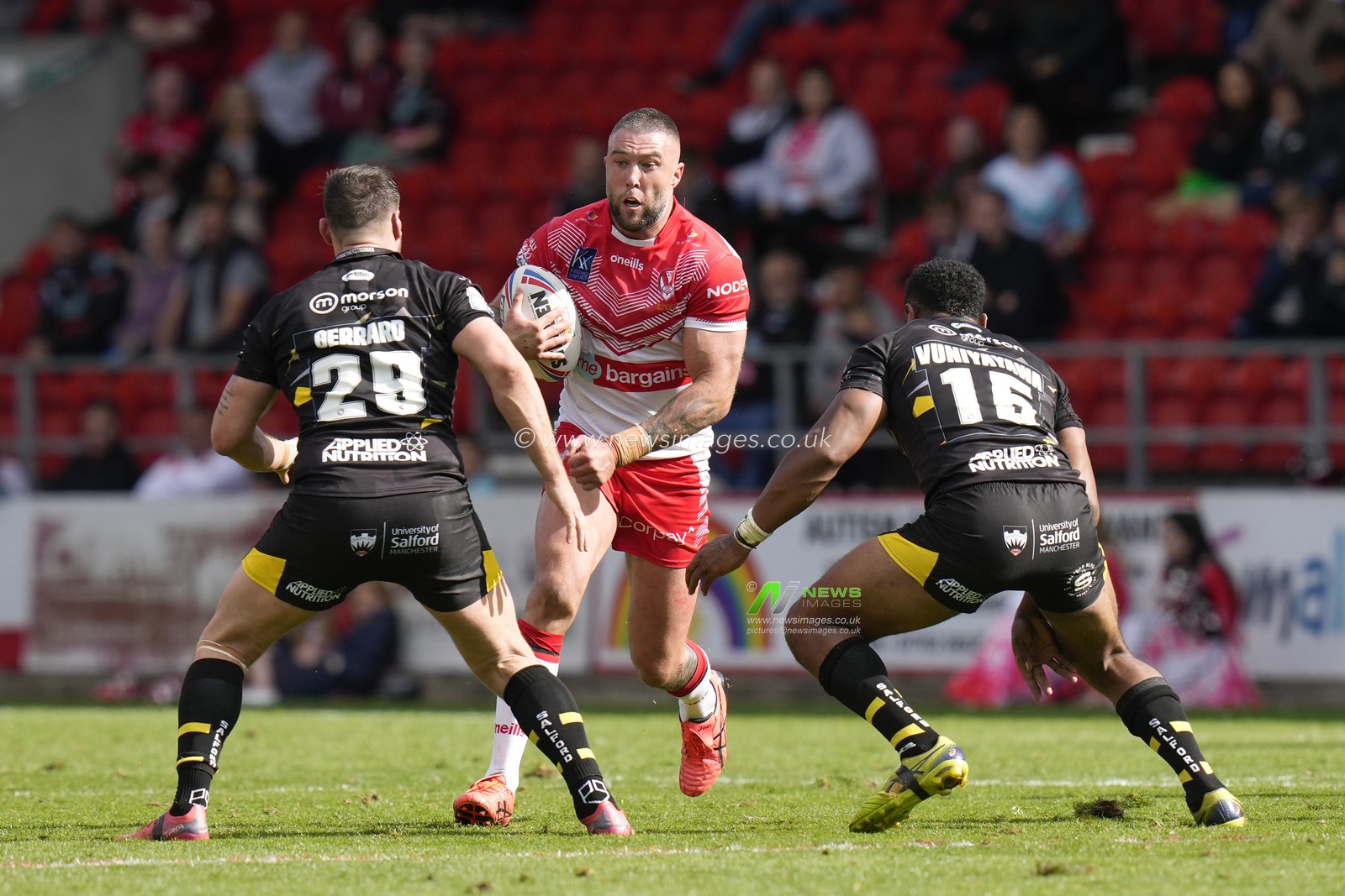 Curtis Sironen #16 of St Helens runs at Deon Cross #28 and King Vuniyayawa of Salford Red Devils during the Betfred Super League match St Helens vs Salford Red Devils at Totally Wicked Stadium, St Helens, United Kingdom, 17th September 2022

(Photo by Steve Flynn/News Images)