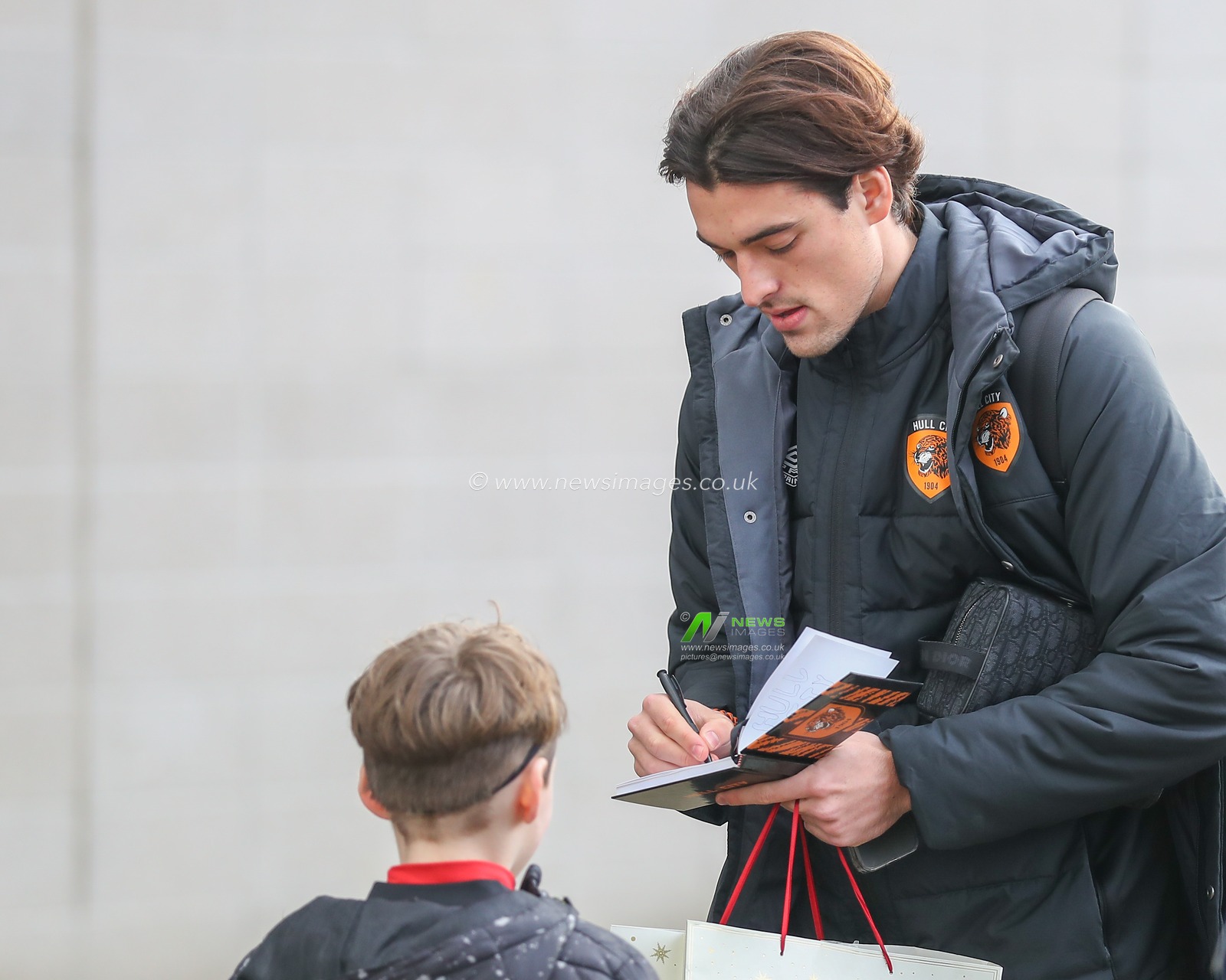 Jacob Greaves #4 of Hull City signs a fans book as he arrives ahead of the Emirates FA Cup Third Round match Hull City vs Fulham at MKM Stadium, Hull, United Kingdom, 7th January 2023

(Photo by Gareth Evans/News Images)