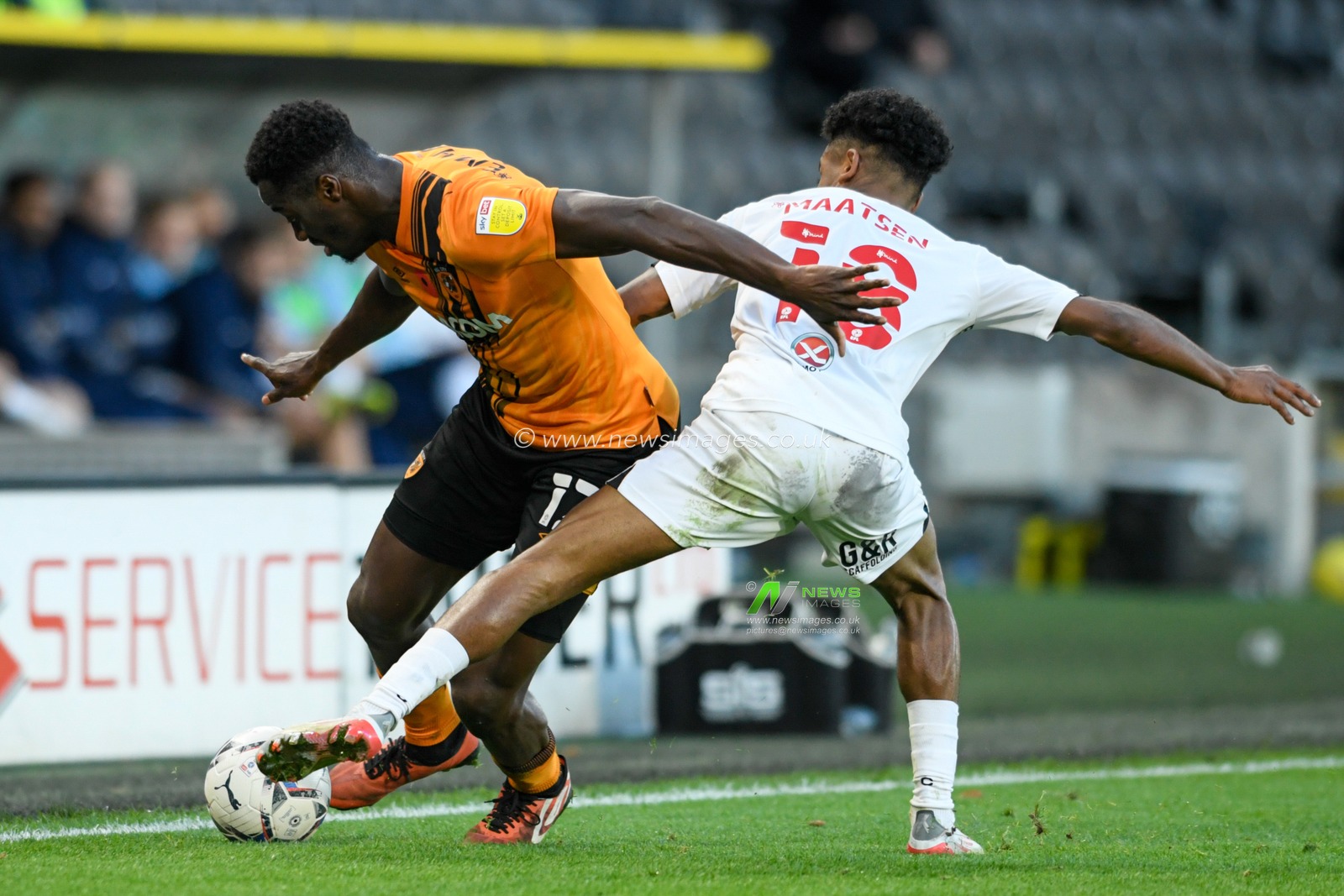 Josh Emmanuel #12 of Hull City looks for a way past Ian Maatsen #18 of Coventry City