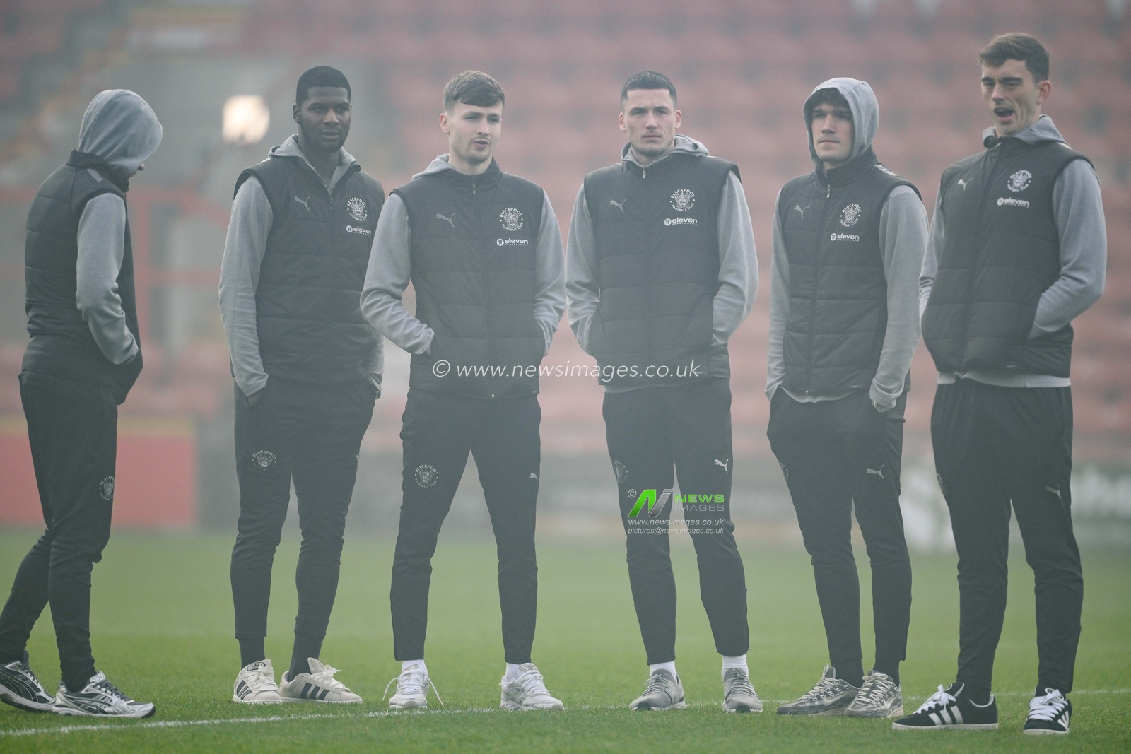 Blackpool  players stand on the foggy pitch as he arrives ahead of the Sky Bet League 1 match Wrexham vs Blackpool at SToK Cae Ras, Wrexham, United Kingdom, 26th December 2024

(Photo by Craig Thomas/News Images)