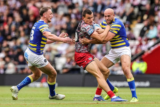 Innes Senior of Leigh Leopards is tackled by James Harrison of Warrington Wolves and Ben Currie of Warrington Wolves during the Betfred Super League round 20 match Leigh Leopards vs Warrington Wolves at Leigh Sports Village, Leigh, United Kingdom on 25 July 2026

(Photo by Alfie Cosgrove/News Images)
