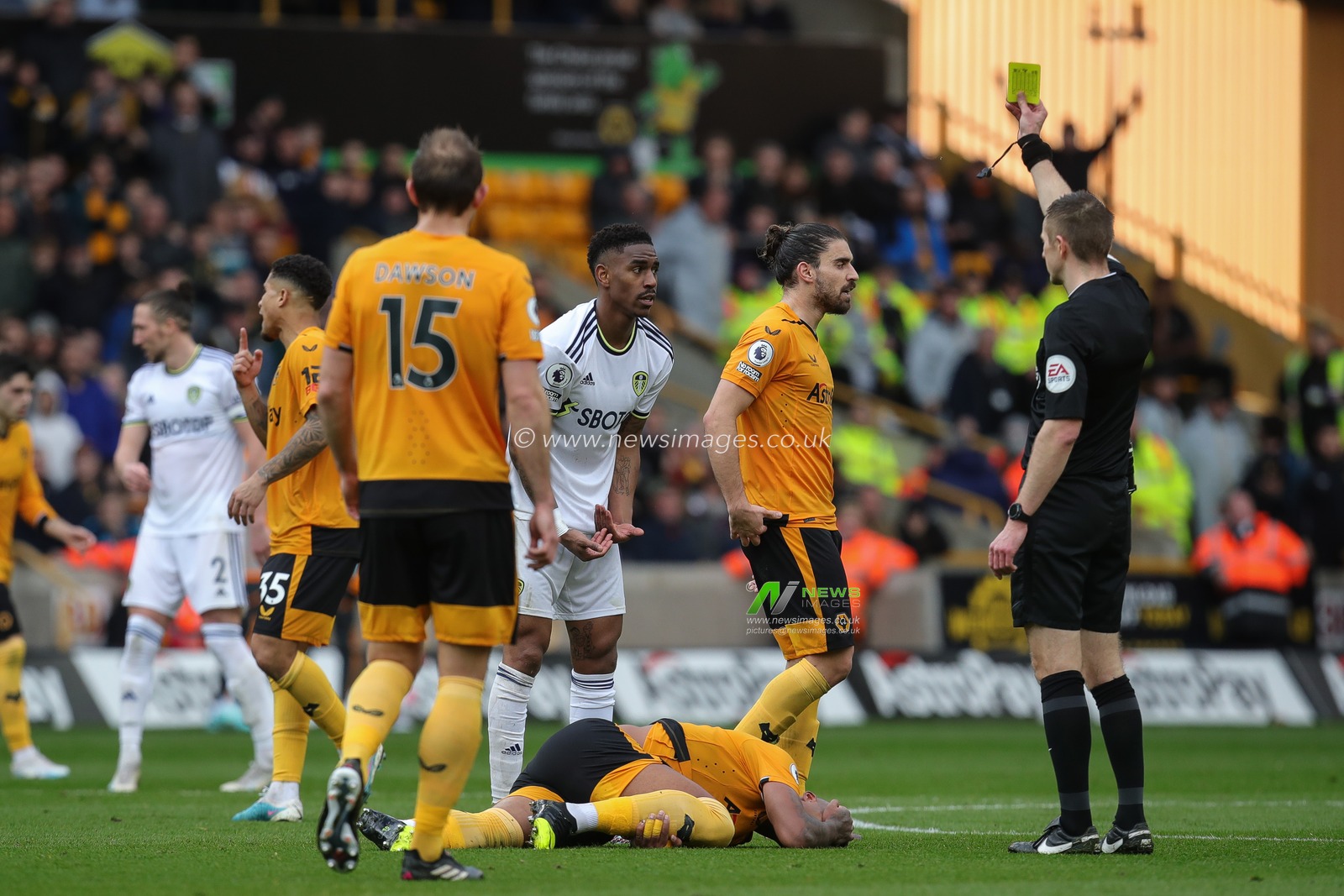 Referee Michael Salisbury awards a yellow card to JÃºnior Firpo #3 of Leeds United during the Premier League match Wolverhampton Wanderers vs Leeds United at Molineux, Wolverhampton, United Kingdom, 18th March 2023

(Photo by James Heaton/News Images)