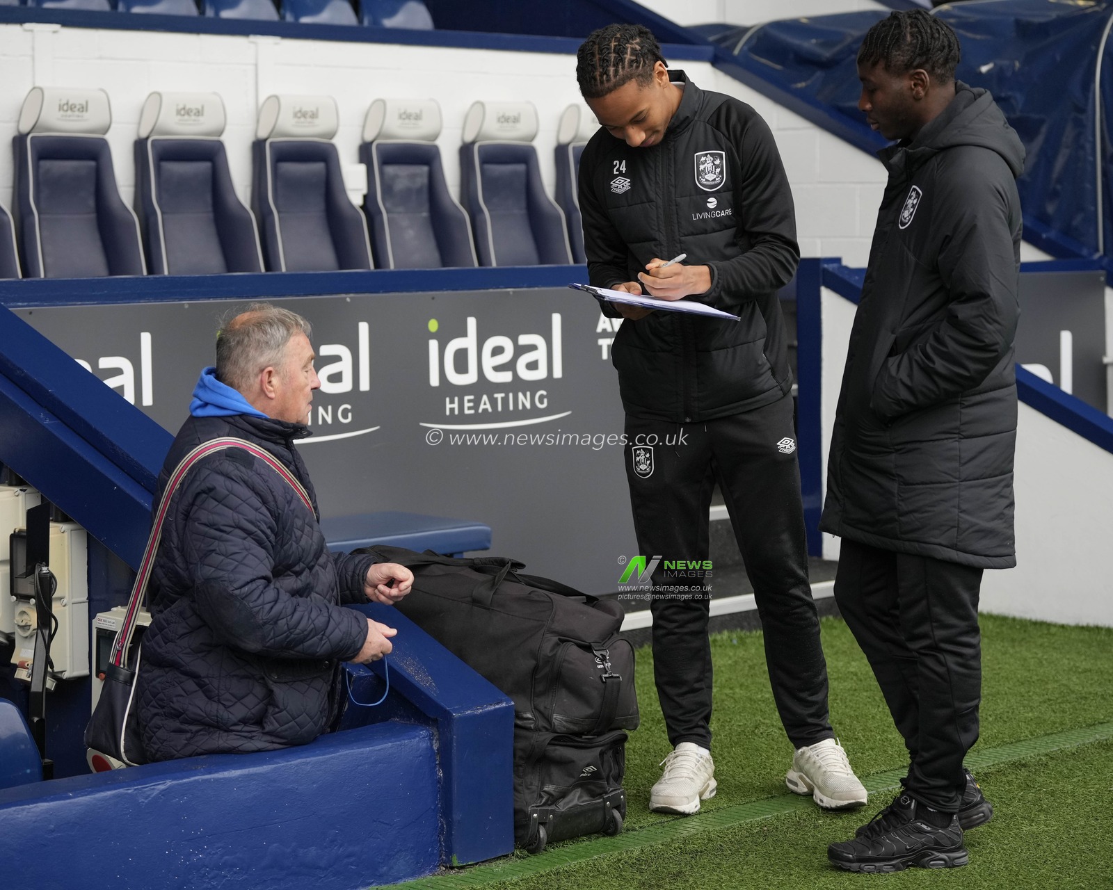 Etienne Camara #24 of Huddersfield Town signs an autograph for a fan before the Sky Bet Championship match West Bromwich Albion vs Huddersfield Town at The Hawthorns, West Bromwich, United Kingdom, 11th March 2023

(Photo by Steve Flynn/News Images)