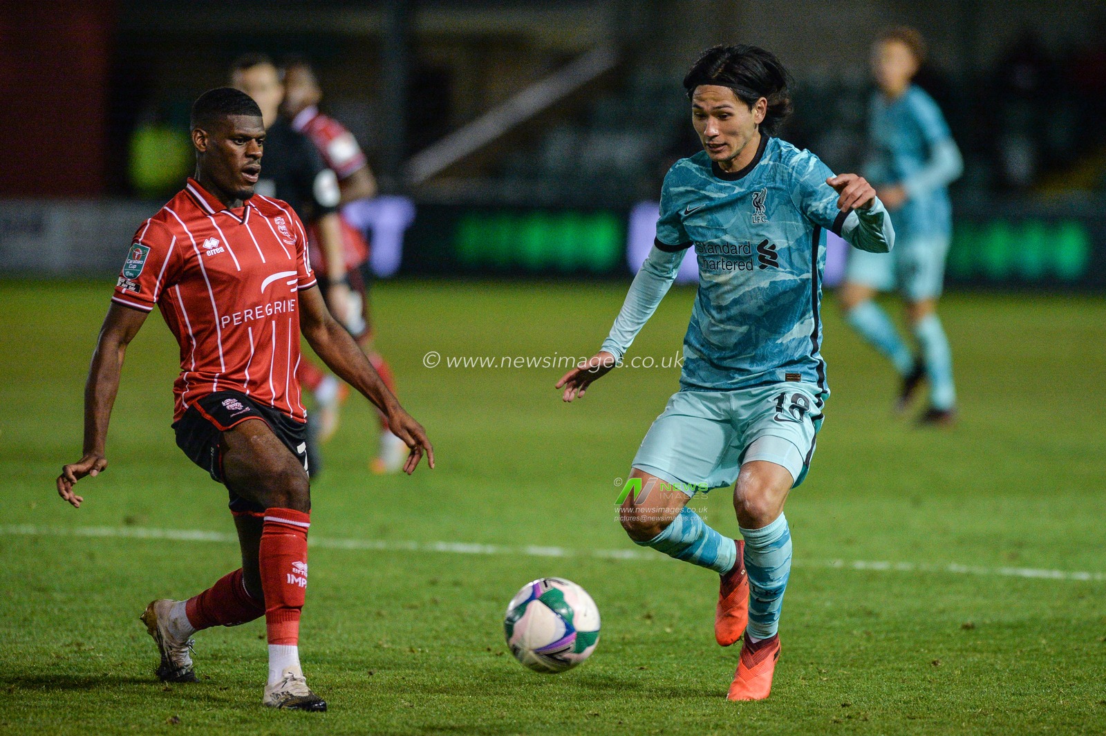 Takumi Minamino (18) of Liverpool in action.