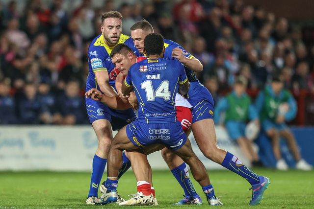 Ryan Hall of Hull KR is tackled by Rodrick Tai of Warrington Wolves and Danny Walker of Warrington Wolves during the Betfred Super League Semi-Finals match Hull KR vs Warrington Wolves at Sewell Group Craven Park, Kingston upon Hull, United Kingdom, 4th October 2024

(Photo by Alfie Cosgrove/News Images)