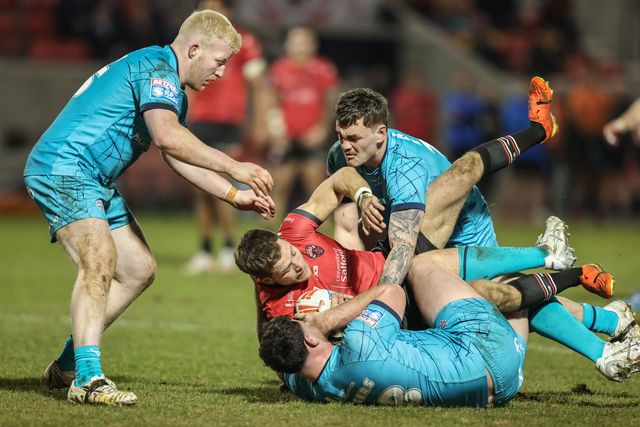Chris Atkin of Salford Red Devils is tackled by Fenton Rogers of Huddersfield Giants and Thomas Deakin of Huddersfield Giants during the Betfred Super League Round 5 match Salford Red Devils vs Huddersfield Giants at Salford Community Stadium, Eccles, United Kingdom, 20th March 2025

(Photo by Alfie Cosgrove/News Images)
