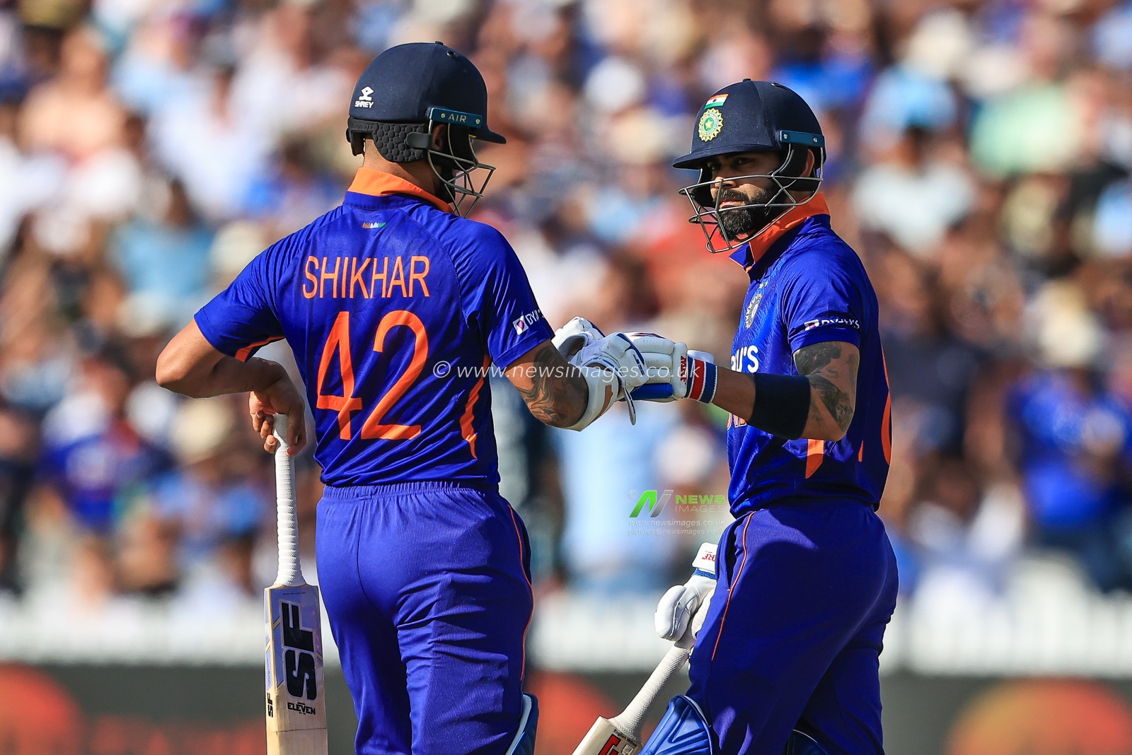 Shikhar Dhawan of India and Virat Kohli bump fists between overs